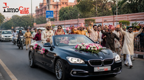 Luxury open-roof BMW wedding car by Limo Car India with bride, groom and wedding procession on a Jaipur city road