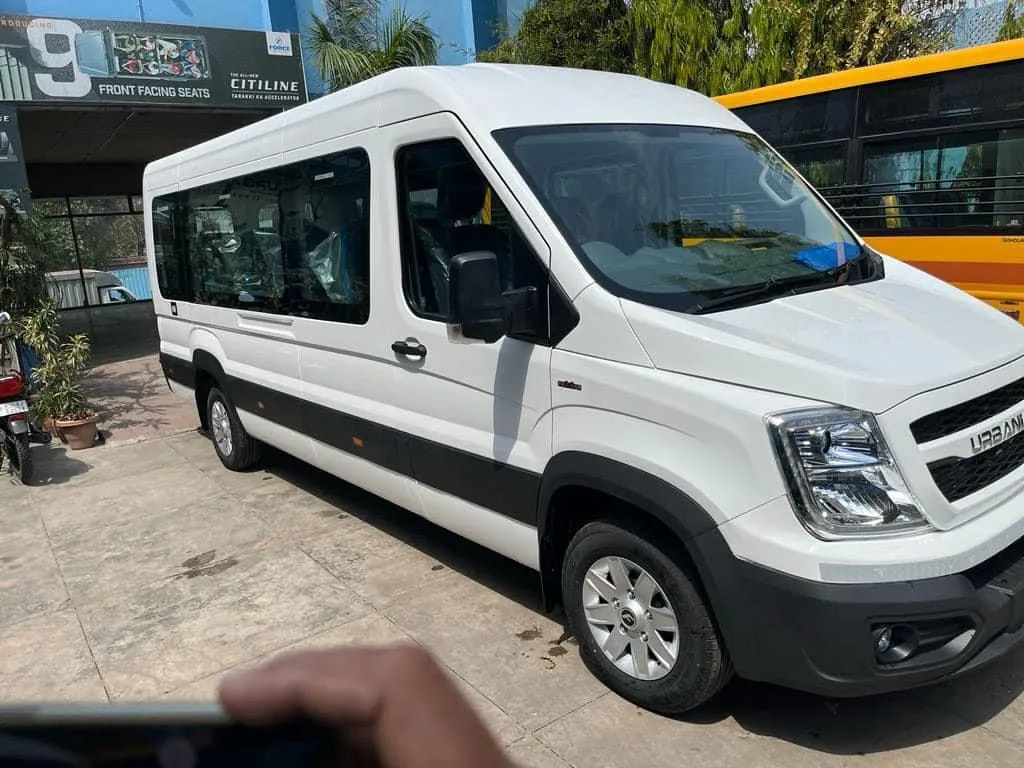 Two Force Urbania luxury vans parked together for commercial and group travel services.