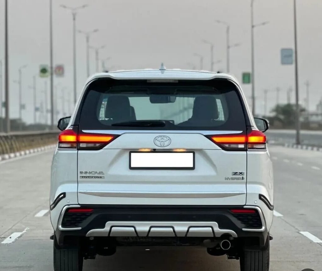 Premium second-row captain seats inside the Toyota Innova Hycross with leather upholstery, armrests, panoramic sunroof, and spacious cabin.