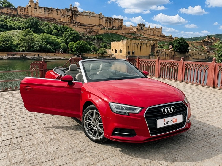 Red Audi A3 convertible with open driver door parked near Amber Fort in Jaipur.