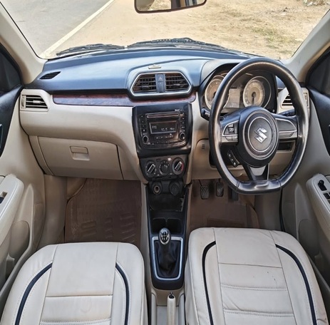 Maruti Suzuki Swift Dzire front cabin interior with clean dashboard, steering wheel, and comfortable seats by Limo Car India.