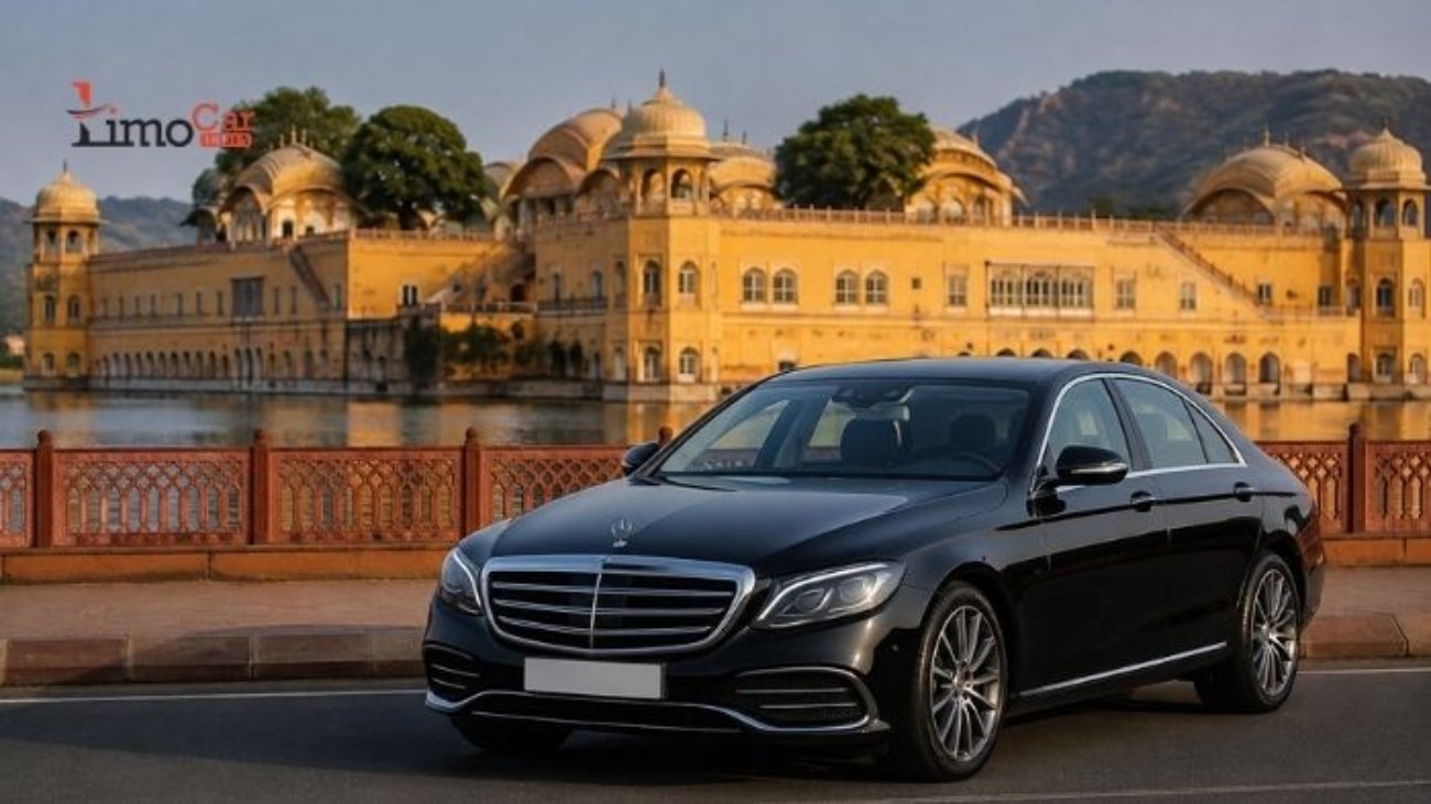Luxury car rental in Jaipur with a premium black sedan near a historic palace