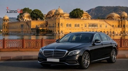 Luxury car rental in Jaipur with a premium black sedan near a historic palace